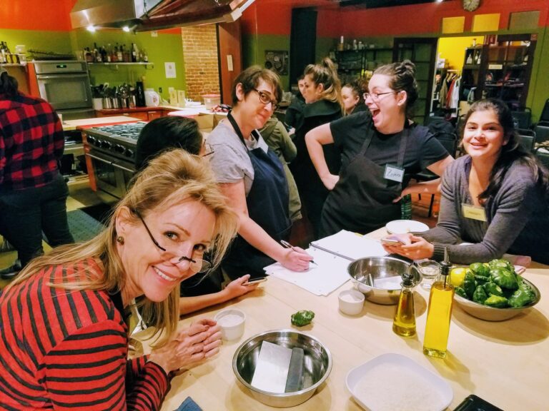 a group of people sitting at a table eating food