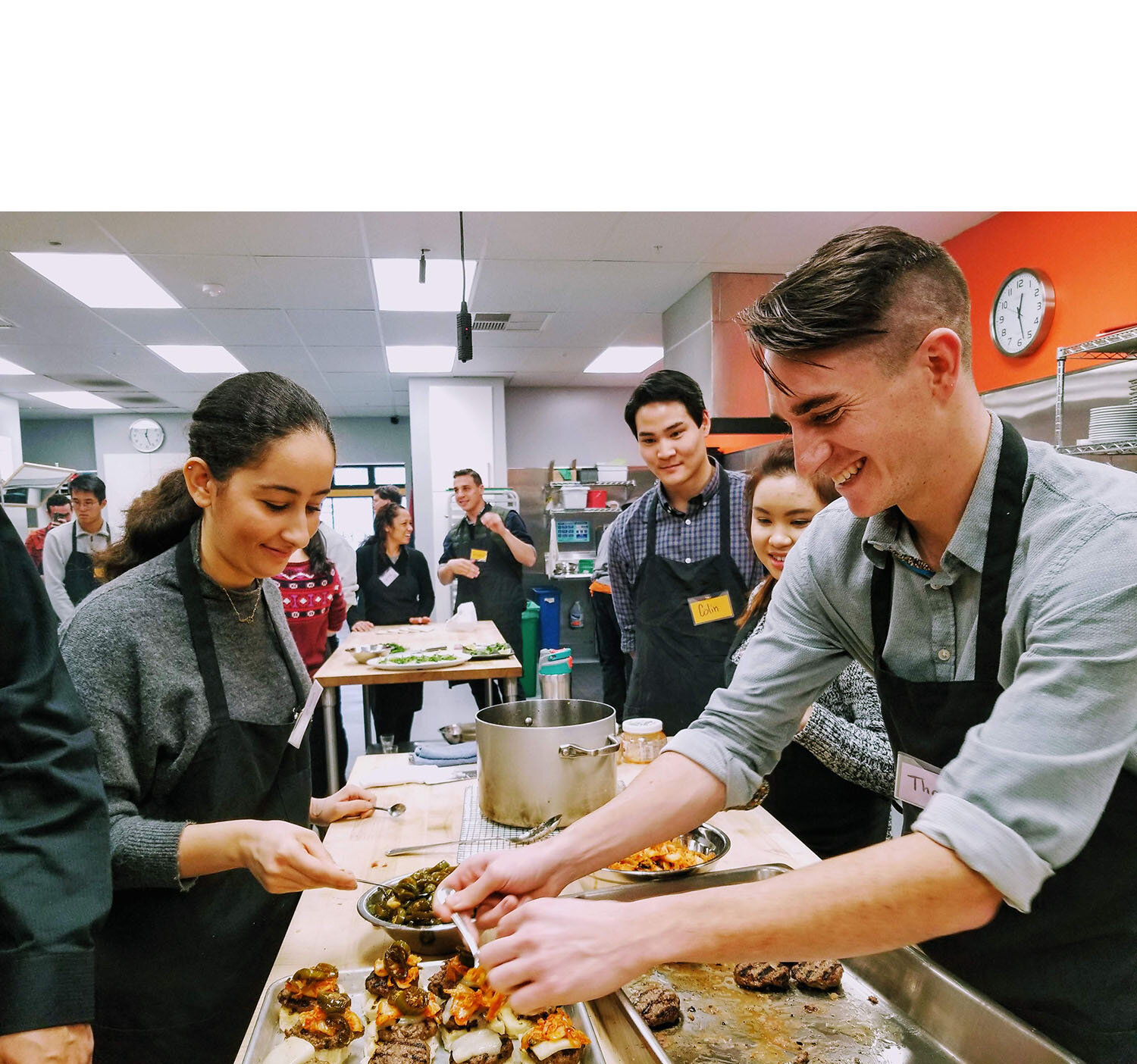 a group of people preparing food in a kitchen