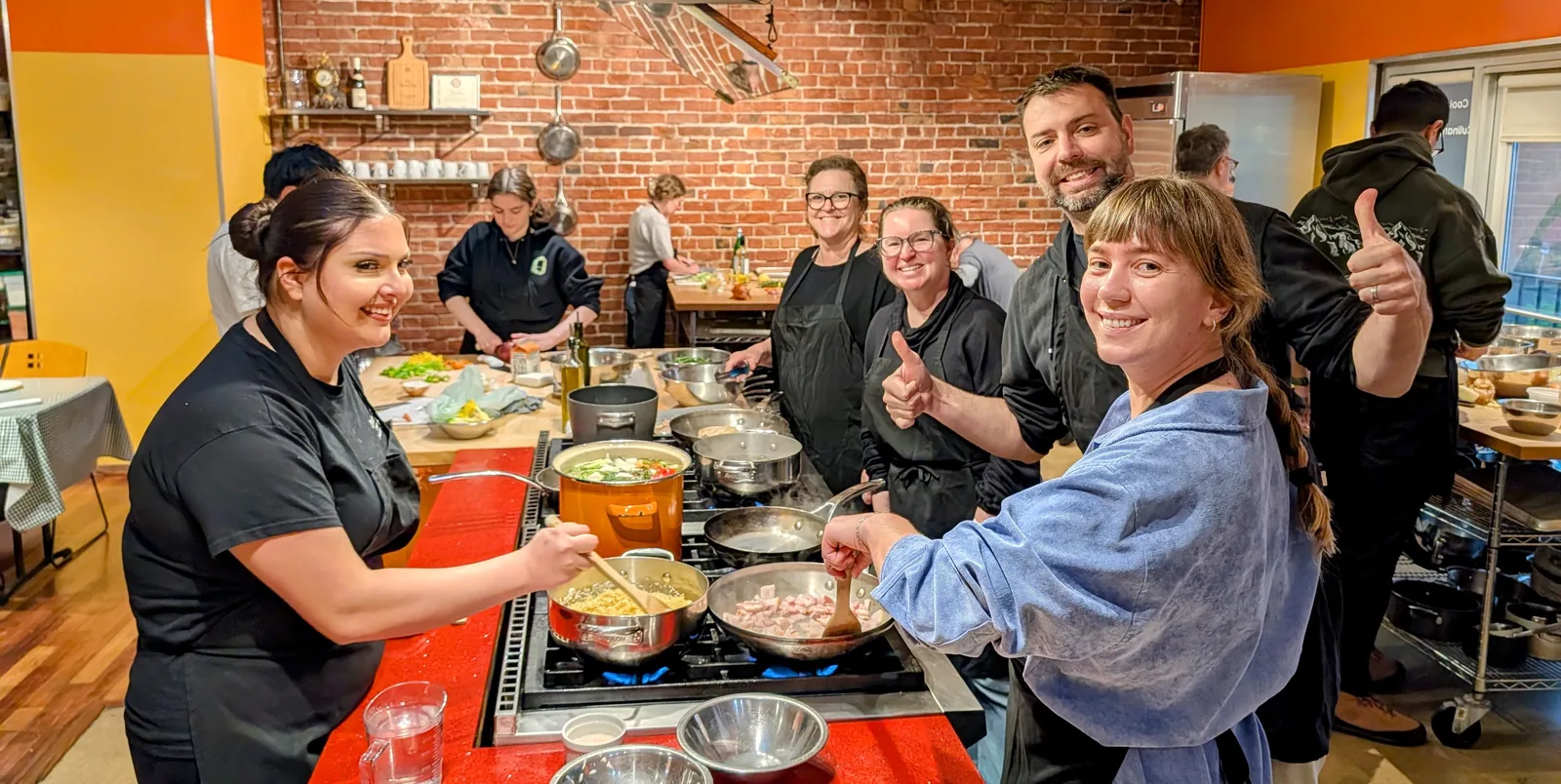 Guests and chefs cooking together at Kitchen on Fire's Berkeley kitchen